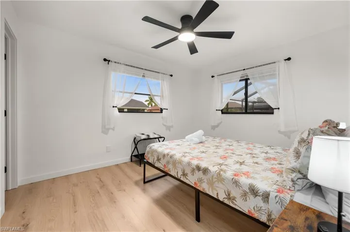 Bedroom featuring multiple windows, light hardwood / wood-style flooring, and ceiling fan