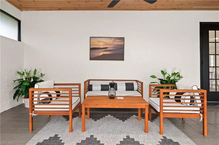Sitting room featuring tile patterned floors, ceiling fan, and wooden ceiling