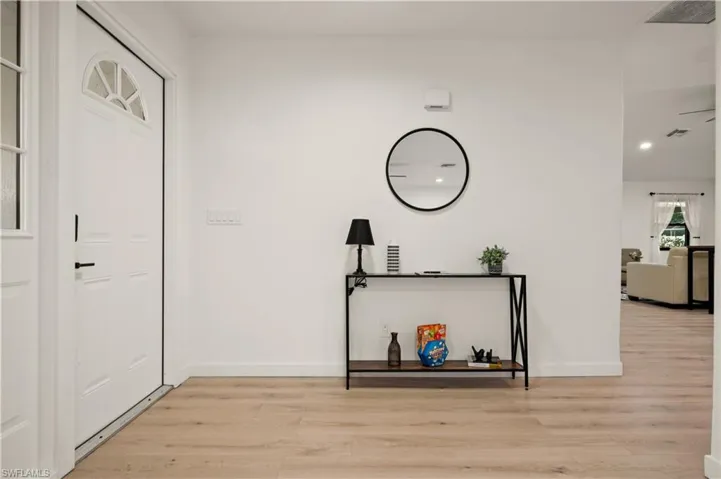Corridor with light hardwood / wood-style floors