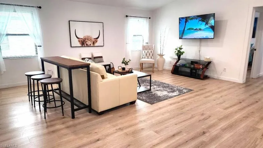 Living room with plenty of natural light and light wood-type flooring