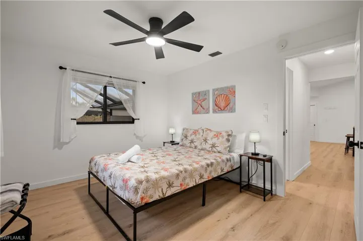 Bedroom with light hardwood / wood-style floors and ceiling fan