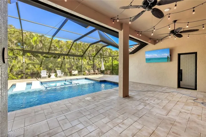 View of swimming pool with a patio and ceiling fan