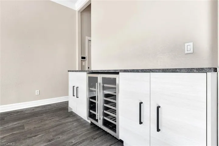 Details with wine cooler, crown molding,
