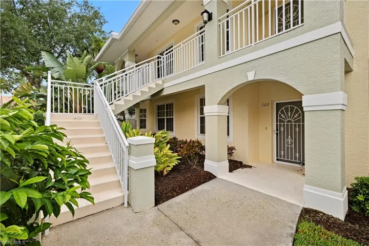 Entrance to property with stucco siding
