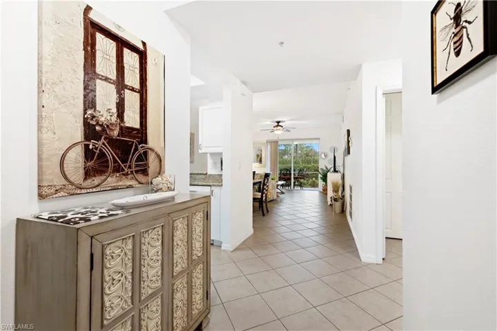 Hall with light tile patterned floors and baseboards