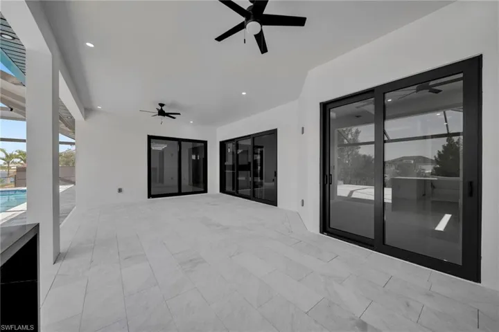 View of patio / terrace with an outdoor pool, a ceiling fan, and french doors