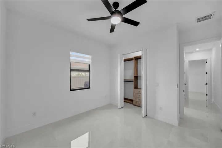 Unfurnished bedroom featuring visible vents, a closet, a ceiling fan, and baseboards