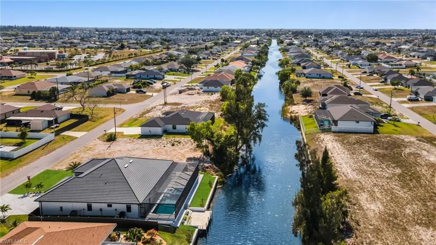 Birds eye view of property with a residential view and a water view