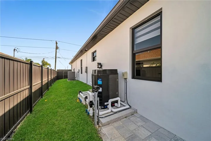 View of yard with central AC unit and a fenced backyard