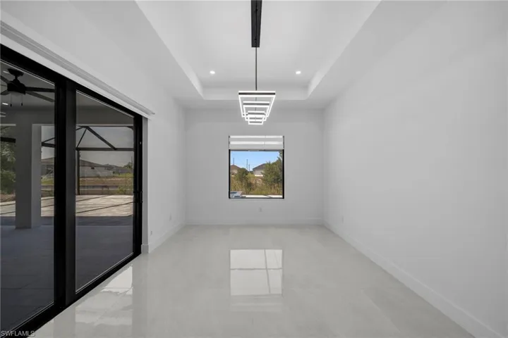 Unfurnished room featuring baseboards, recessed lighting, a raised ceiling, and light tile patterned flooring