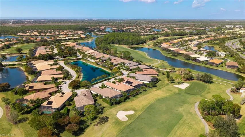 View of property location featuring nearby suburban area, a nearby body of water, and a golf course