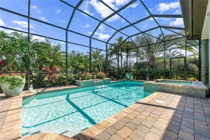 Integrated pool / spa featuring a sunroom, a lanai, and a patio