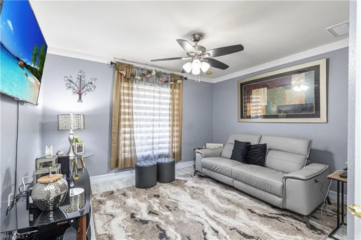 2nd Living room with ceiling fan, ornamental molding, and wood-type flooring, closet attached