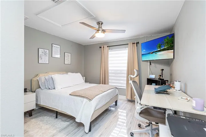 Bedroom with ceiling fan and light hardwood / wood-style flooring