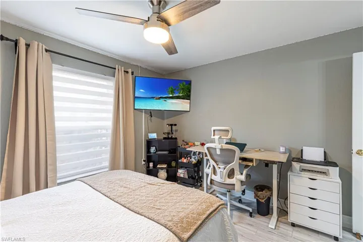 Bedroom with light hardwood / wood-style floors and ceiling fan