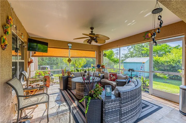 Sunroom / solarium featuring ceiling fan and a wealth of natural light