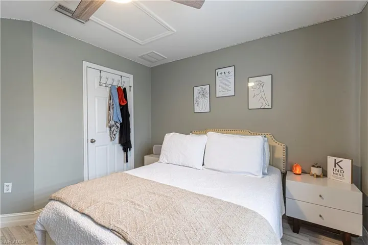 Bedroom with a closet, wood-type flooring, and ceiling fan