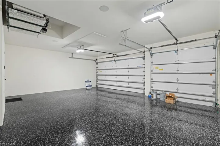 Garage featuring a garage door opener