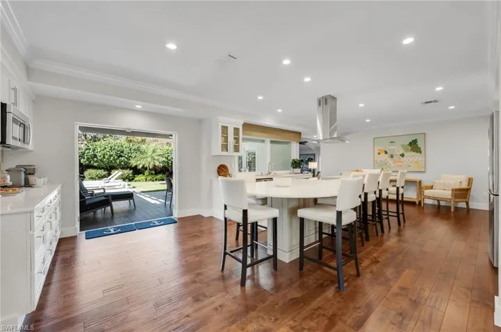 Counter height kitchen island seats eight comfortably.