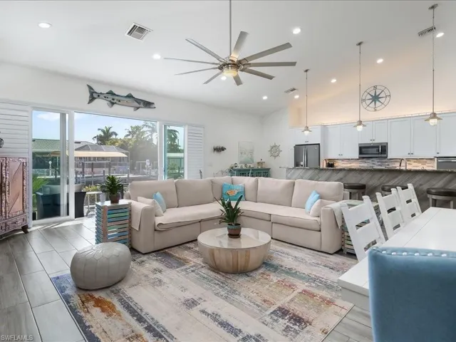 Living area featuring ceiling fan, vaulted ceiling, and recessed lighting