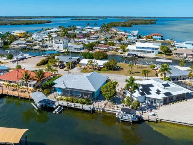 Aerial perspective of suburban area featuring a large body of water