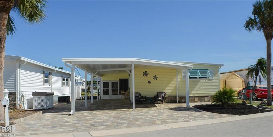 Exterior Front with reinforced carport and extra parking