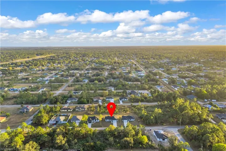 Aerial view of property's location featuring nearby suburban area