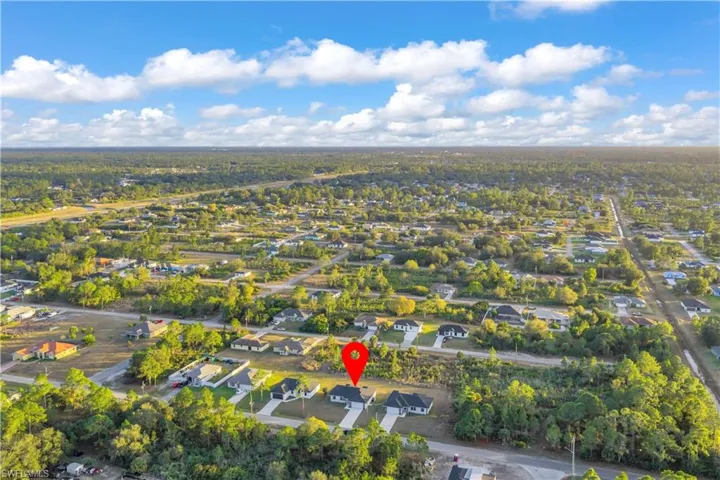 Aerial overview of property's location with nearby suburban area