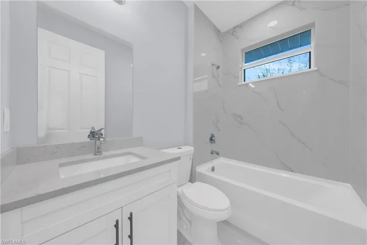 Full bath with vanity and shower / washtub combination