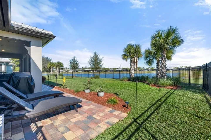 View of yard with a patio area and a water view
