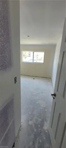 Unfurnished room featuring concrete flooring