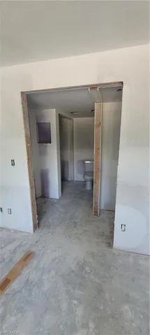 Hallway featuring concrete flooring