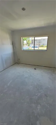 Unfurnished room featuring concrete flooring