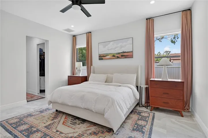 Bedroom featuring light-toned flooring, recessed lighting, and a ceiling fan