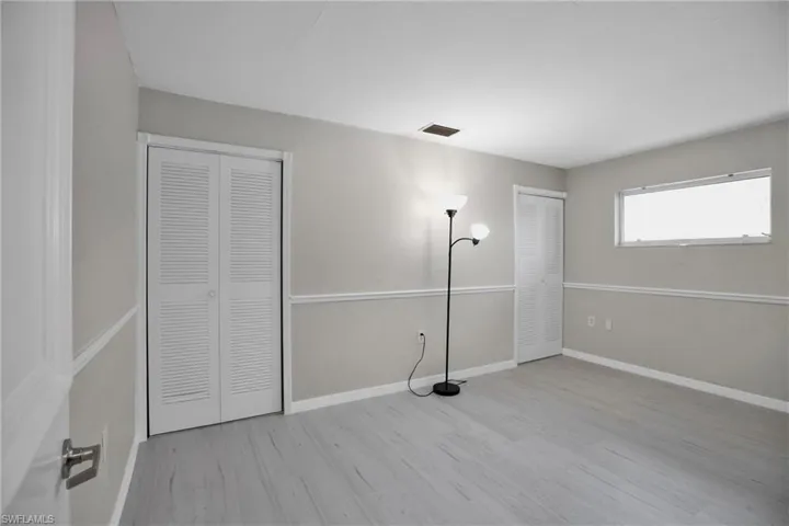 2nd Bedroom with light hardwood / wood-style flooring and two closets
