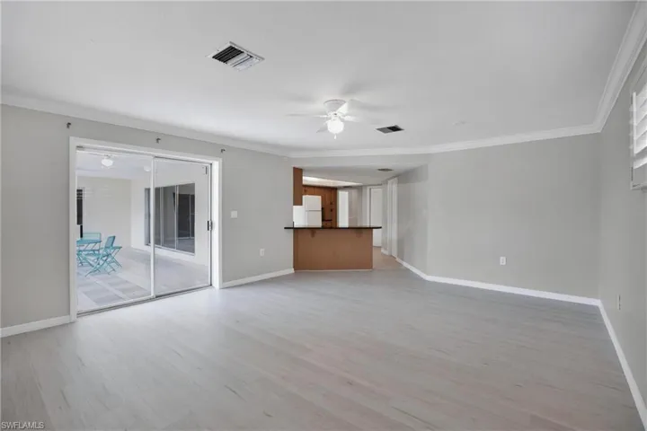 Large Dining Room / Den Combo with crown molding, light hardwood / wood-style flooring, and ceiling fan