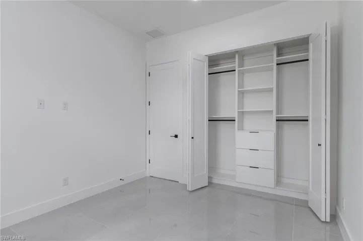 Built-in closet with shelving and drawer storage