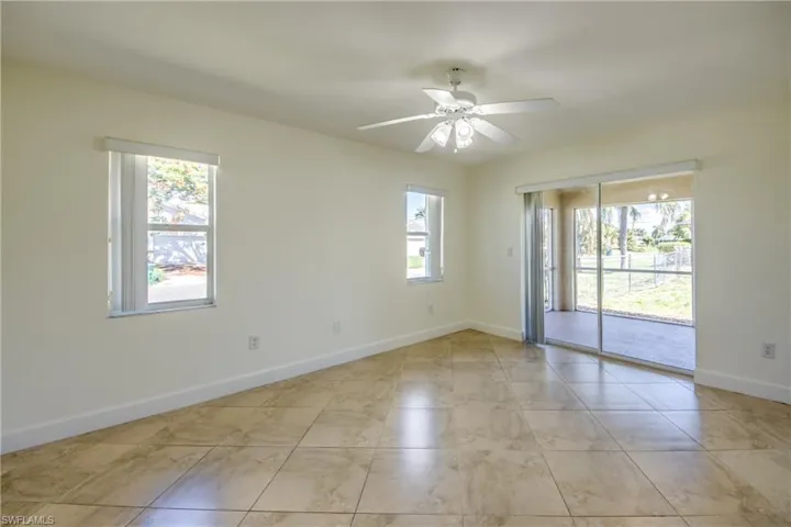 Unfurnished room with baseboards and ceiling fan