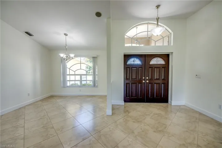 Foyer entrance featuring a chandelier and tile patterned flooring