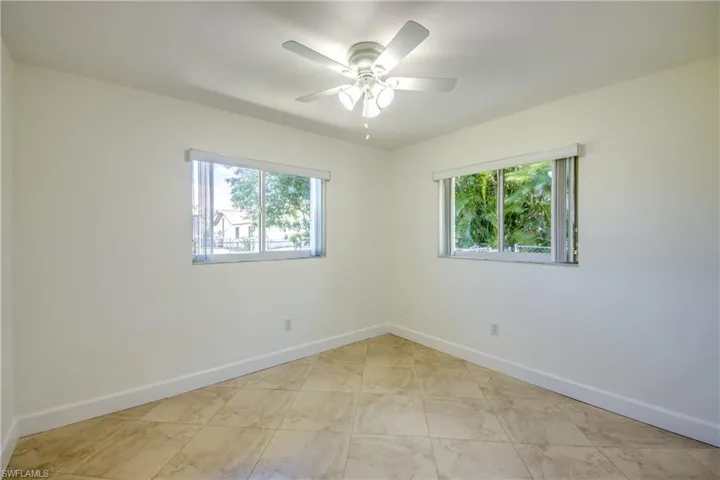 Spare room with plenty of natural light and a ceiling fan
