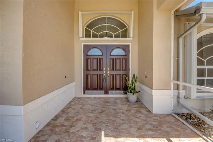 View of exterior entry featuring stucco siding