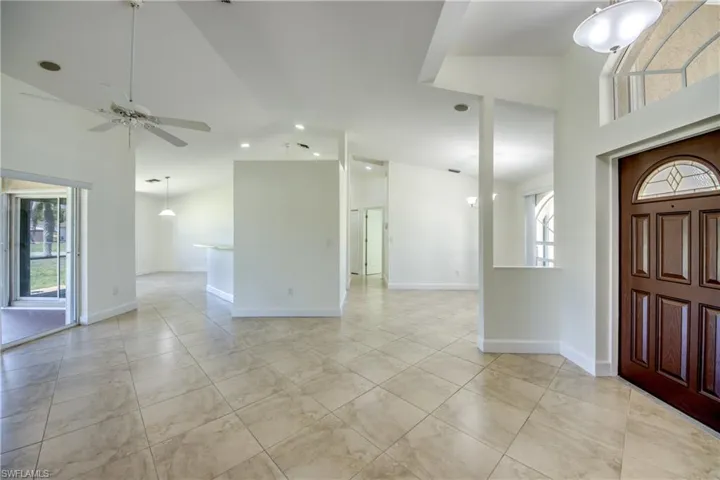 Foyer entrance featuring a ceiling fan and high vaulted ceiling