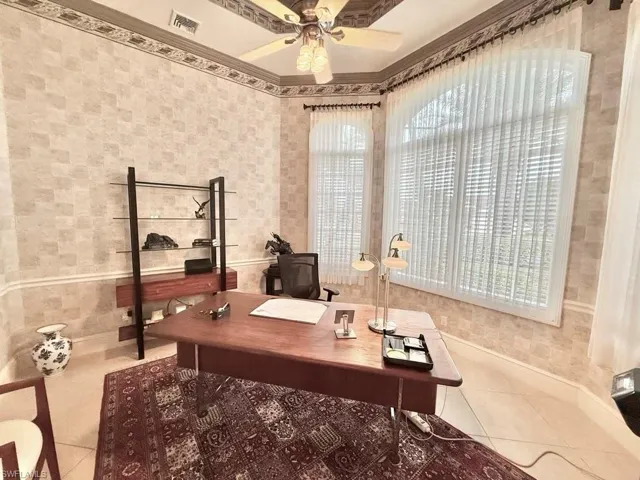 Office area with tile patterned flooring, ornamental molding, and ceiling fan