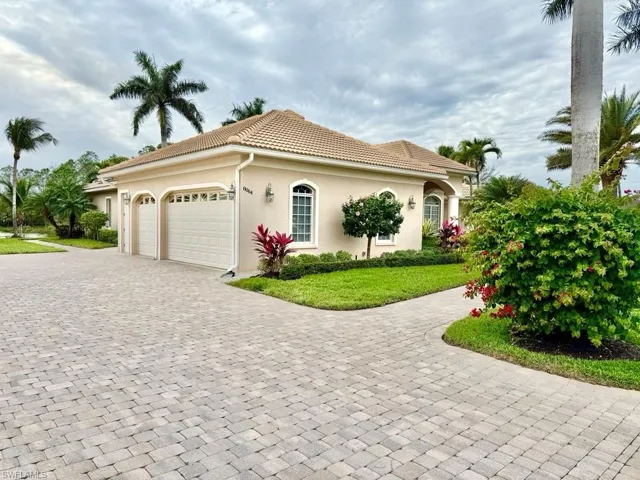 View of front of house featuring a garage and a front lawn