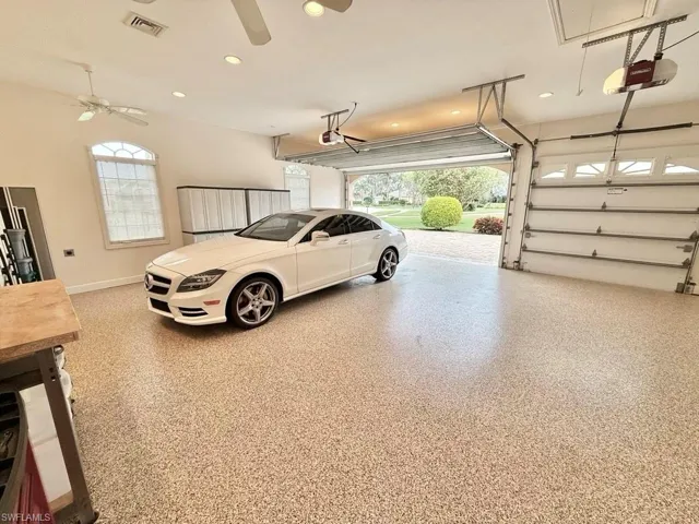 Garage with a garage door opener and ceiling fan