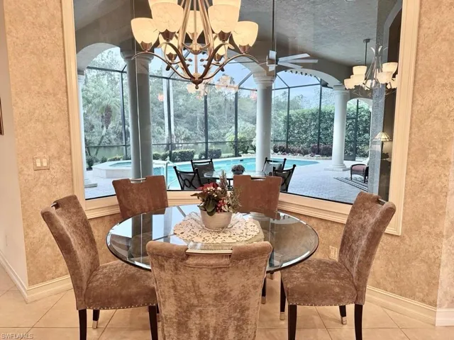 Sunroom featuring a wealth of natural light and an inviting chandelier