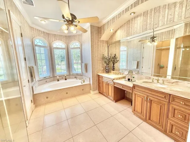 Bathroom featuring crown molding, ceiling fan, vanity, and tile patterned flooring
