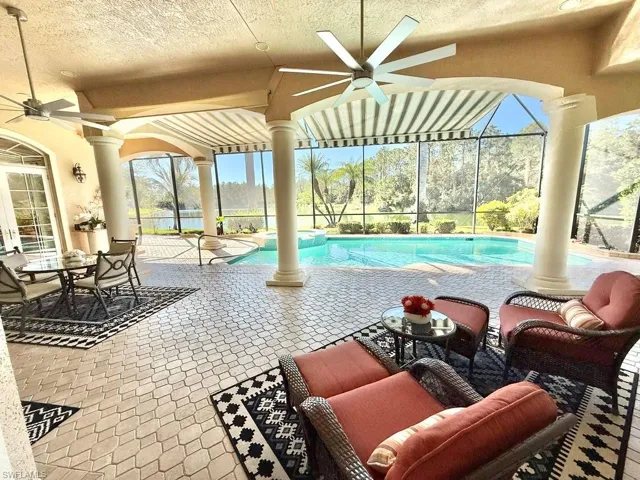 View of swimming pool featuring a lanai, a patio, and ceiling fan