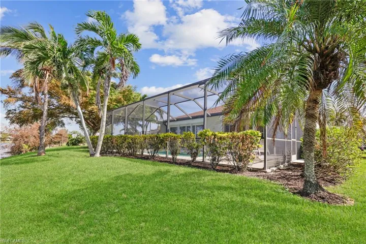 View of yard featuring a screened lanai