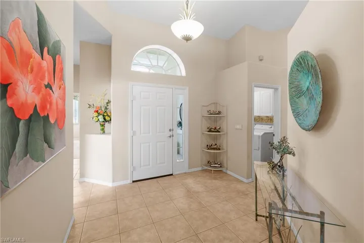 Tiled entrance foyer with a towering ceiling